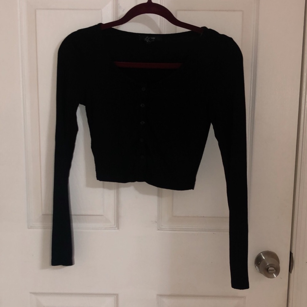 Cropped, black long sleeve.
